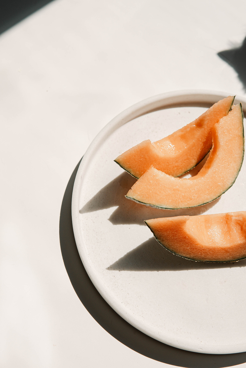 Sliced Orange Fruit on White Ceramic Plate