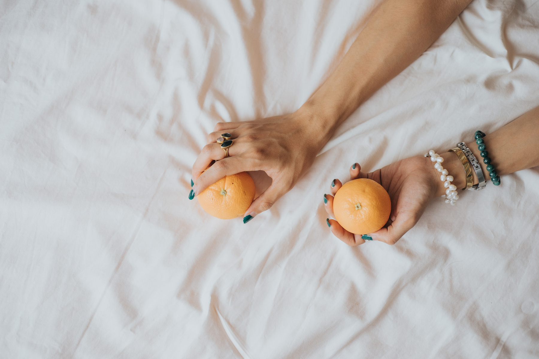 Top View of Person's Hands Holding Oranges
